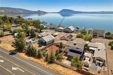 birds eye view of property featuring a water and mountain view