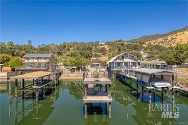 view of dock featuring a water and mountain view