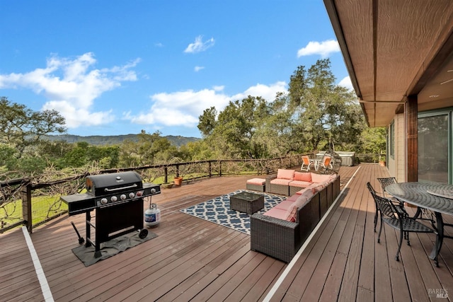 deck with area for grilling and an outdoor hangout area