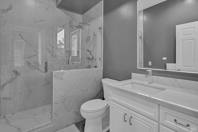 bathroom featuring vanity, toilet, and walk in shower