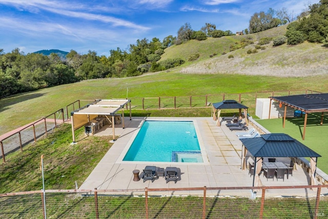 view of swimming pool with a gazebo, a patio area, a trampoline, a shed, and a lawn