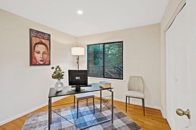home office with wood finished floors and baseboards