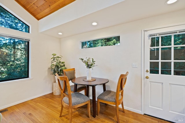 dining space with a wealth of natural light, wood ceiling, lofted ceiling, and light wood-type flooring