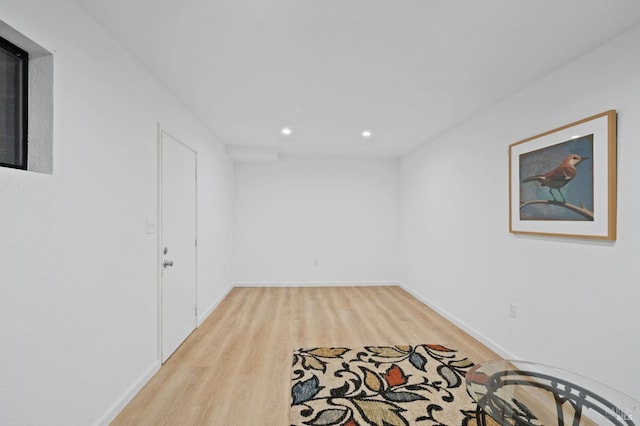 basement with recessed lighting, light wood-style flooring, and baseboards