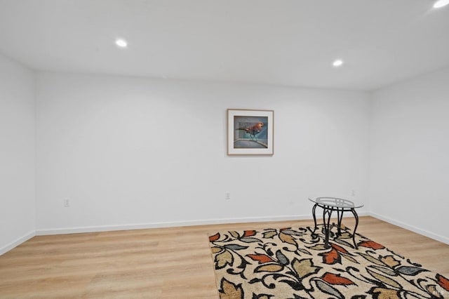 interior space featuring recessed lighting, baseboards, and wood finished floors
