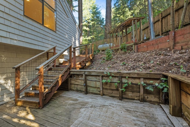 wooden deck featuring stairway and fence