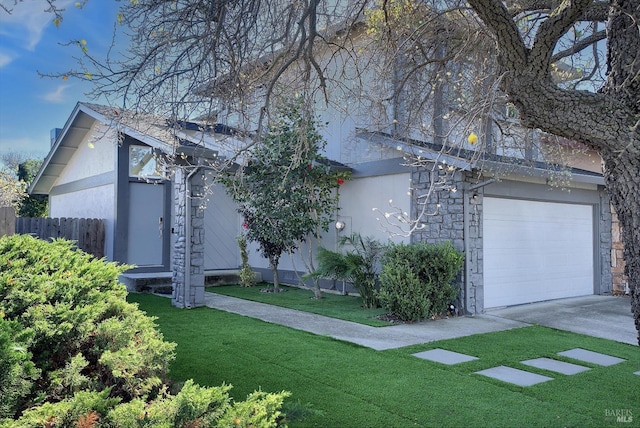 view of side of property featuring a yard and a garage