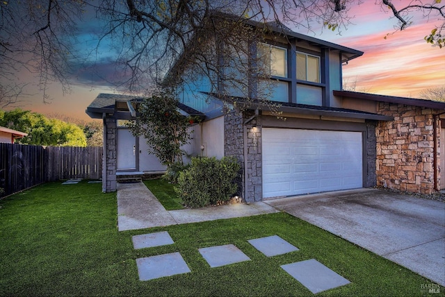 view of front facade with a lawn and a garage