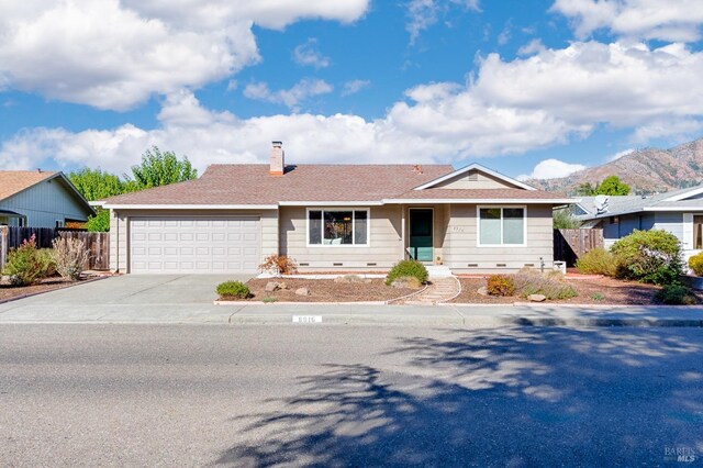 ranch-style house with a mountain view and a garage