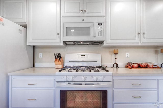 kitchen with white appliances, light countertops, and white cabinets