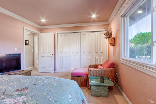 bedroom featuring light carpet, ornamental molding, a closet, and baseboards