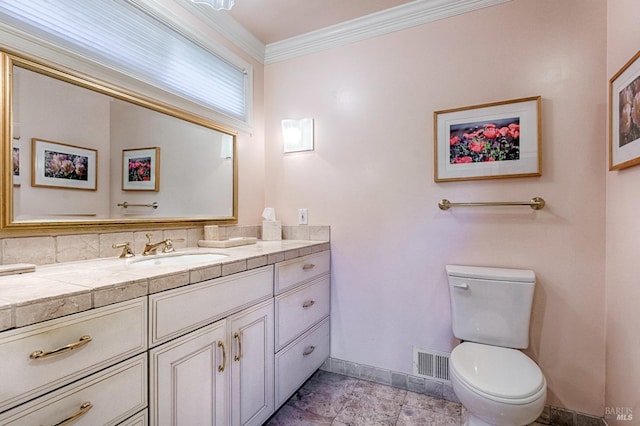 bathroom with crown molding, visible vents, toilet, vanity, and baseboards