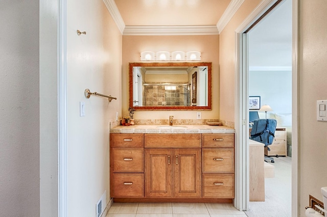 full bath featuring visible vents, connected bathroom, tiled shower, ornamental molding, and vanity