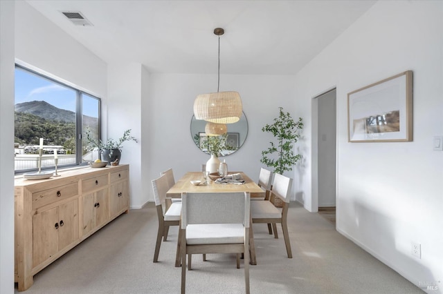 carpeted dining room featuring a mountain view