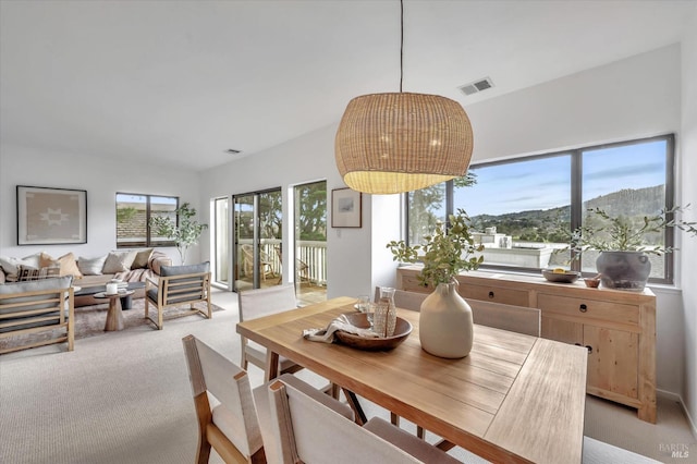 carpeted dining area with a mountain view