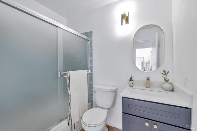 full bathroom with vanity, bath / shower combo with glass door, and toilet