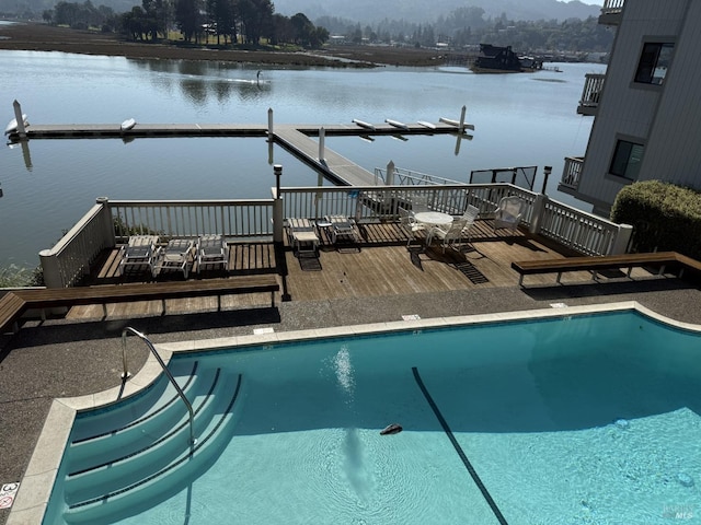 view of swimming pool with a deck with water view