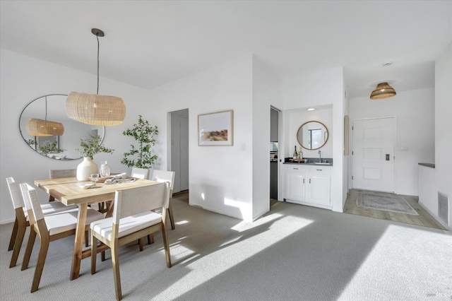 dining room with sink and carpet