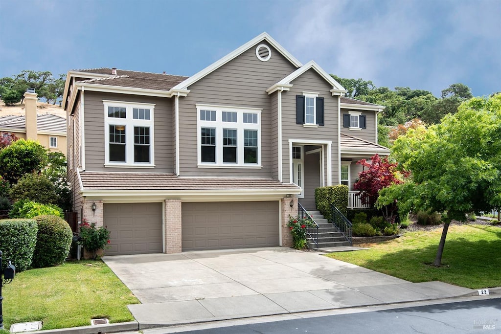 view of front of home featuring a garage and a front lawn