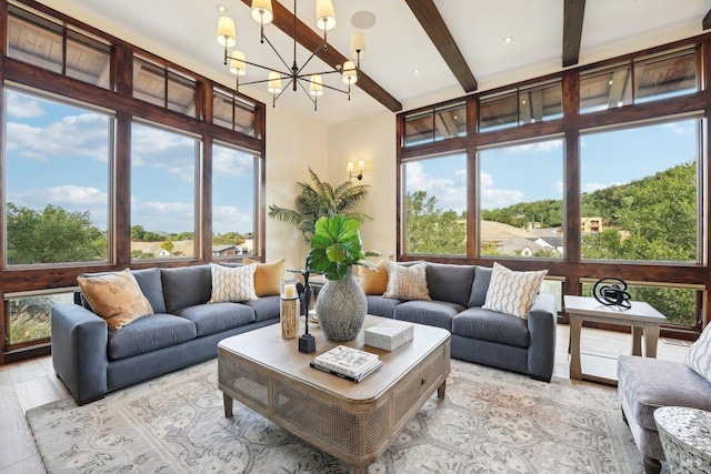 sunroom / solarium with plenty of natural light, a notable chandelier, and beamed ceiling