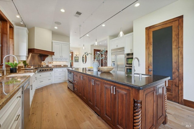 kitchen with a kitchen island, appliances with stainless steel finishes, and white cabinets