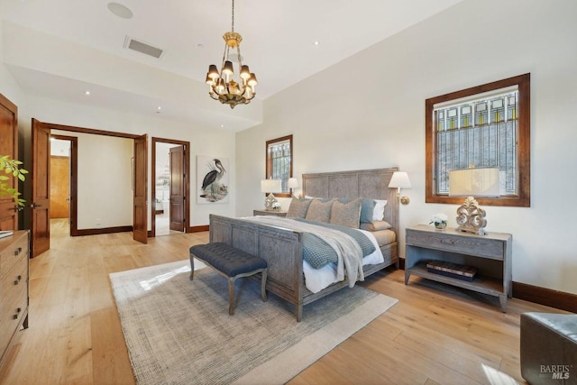 bedroom with light wood finished floors, baseboards, visible vents, and a notable chandelier