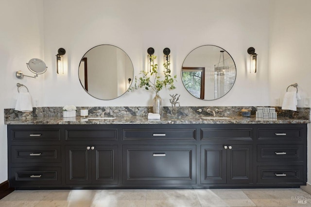 bathroom featuring a sink and double vanity