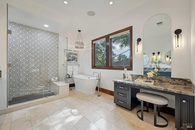 bathroom with recessed lighting, vanity, baseboards, visible vents, and a soaking tub