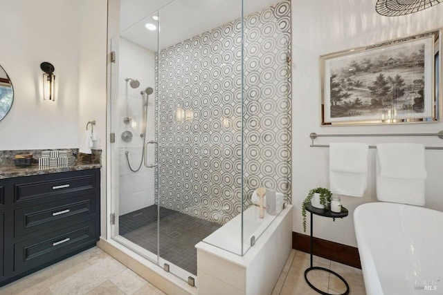 full bath featuring vanity, baseboards, a freestanding bath, a tile shower, and tile patterned floors