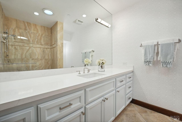 bathroom with visible vents, baseboards, vanity, a walk in shower, and recessed lighting