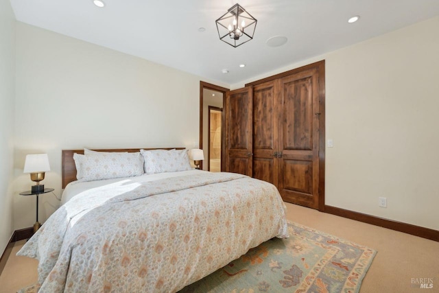 bedroom with recessed lighting, carpet, an inviting chandelier, and baseboards