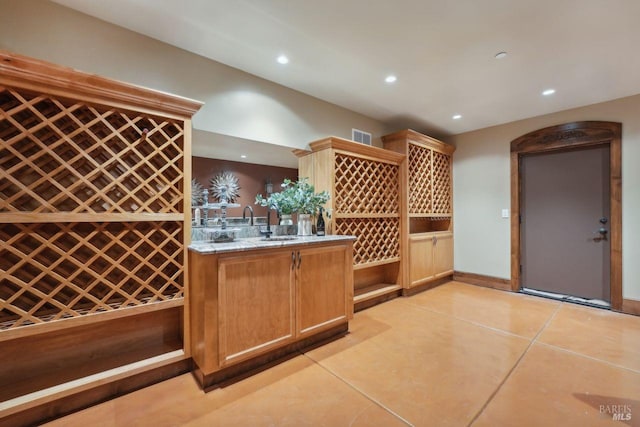 wine area featuring light tile patterned floors, bar, visible vents, and recessed lighting