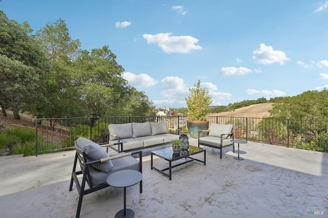 view of patio featuring an outdoor hangout area and fence