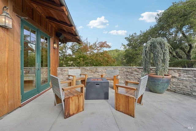 view of patio with a fire pit and french doors