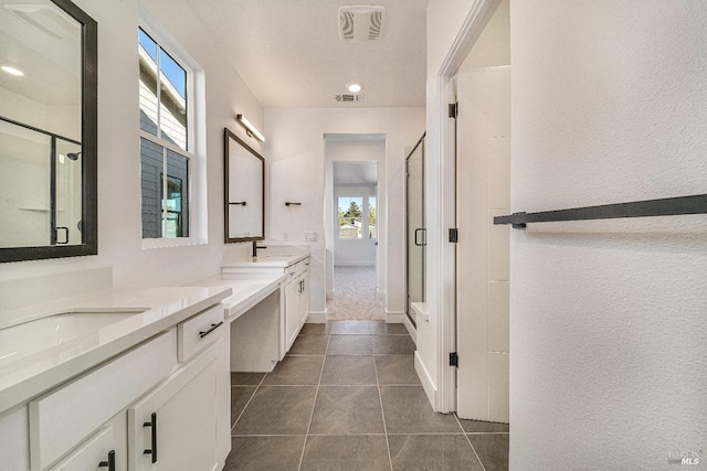 bathroom featuring vanity, tile patterned floors, and an enclosed shower