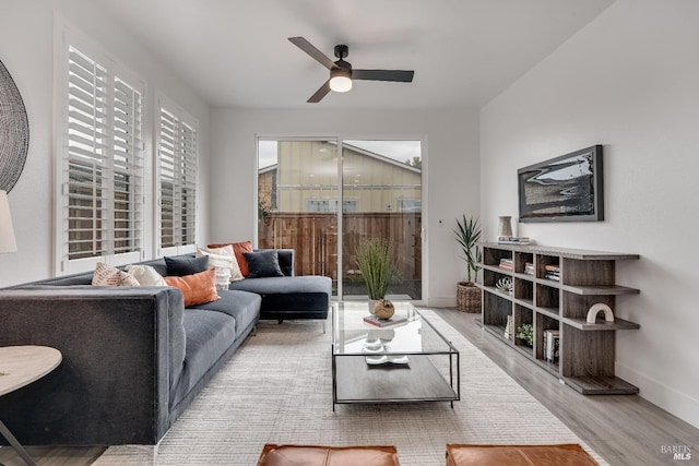 living room featuring light wood-type flooring and ceiling fan