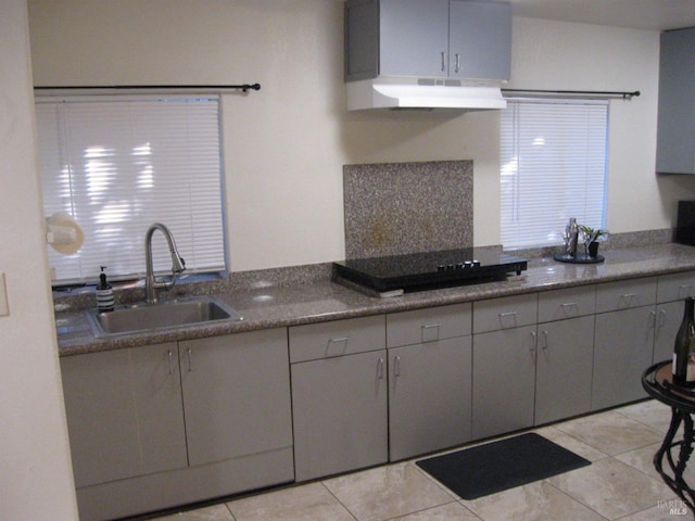 kitchen featuring sink, black electric cooktop, gray cabinets, and light tile patterned flooring