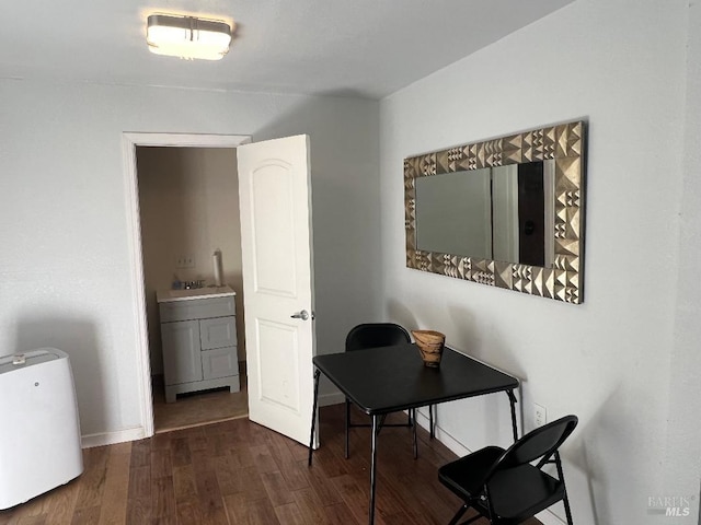 office with sink and dark wood-type flooring