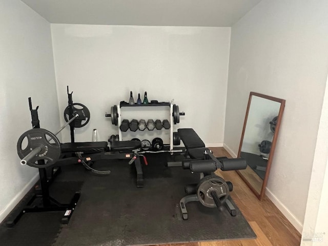 workout area with light hardwood / wood-style floors