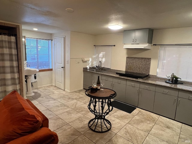 kitchen with sink, black electric stovetop, light tile patterned floors, and gray cabinets