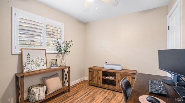 office with light hardwood / wood-style floors and ceiling fan