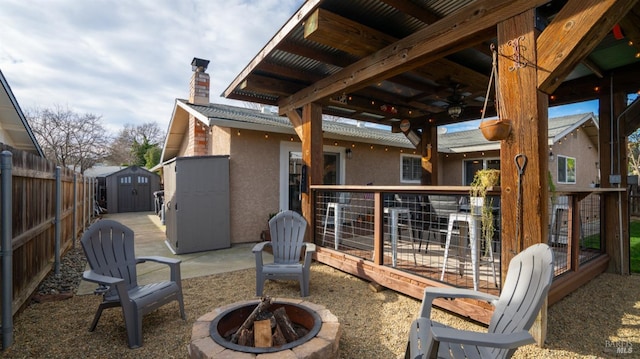 view of patio / terrace featuring a shed and a fire pit