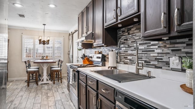 kitchen featuring crown molding, stainless steel electric stove, backsplash, and pendant lighting