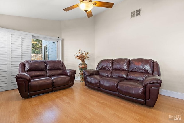 living room with light hardwood / wood-style floors and ceiling fan