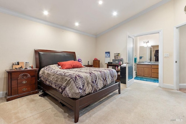 carpeted bedroom with ornamental molding and connected bathroom