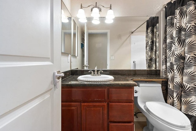 bathroom featuring a shower with curtain, vanity, and toilet