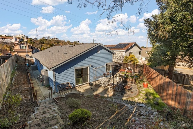 back of property with a patio and central AC