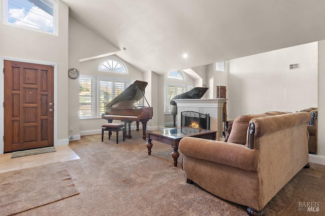 living room with carpet and high vaulted ceiling