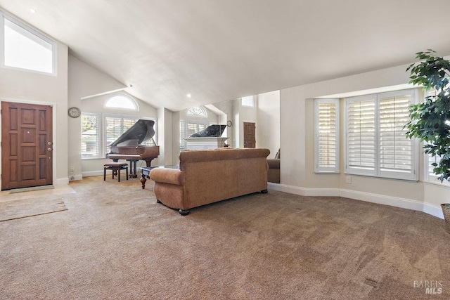 carpeted living room with high vaulted ceiling