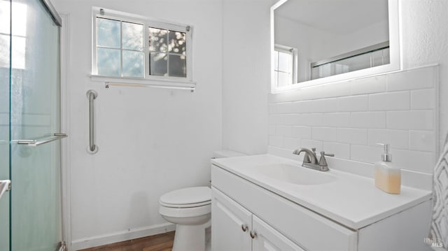 bathroom with wood-type flooring, an enclosed shower, toilet, decorative backsplash, and vanity